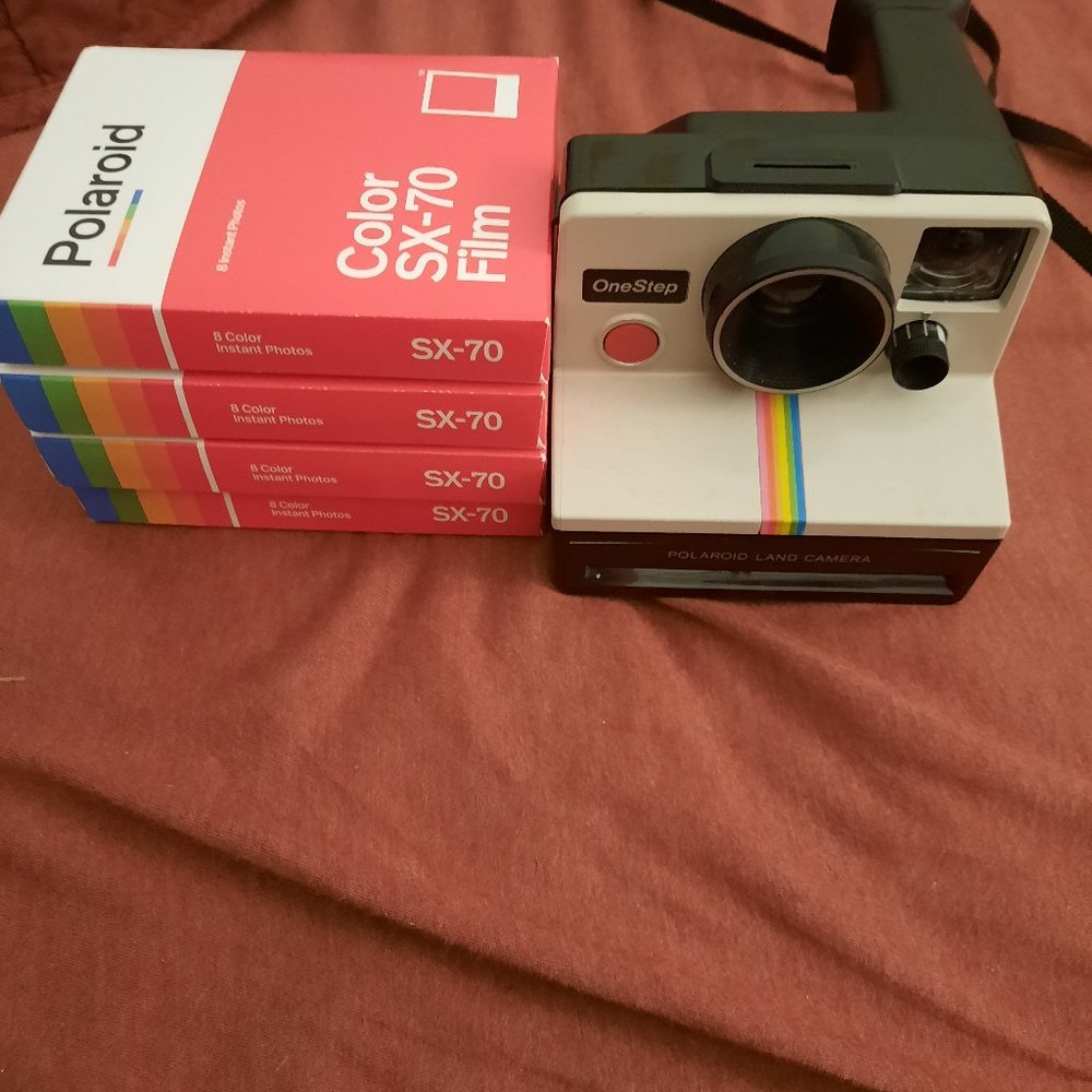 Vintage Polaroid SX 70 land camera with four packs new film